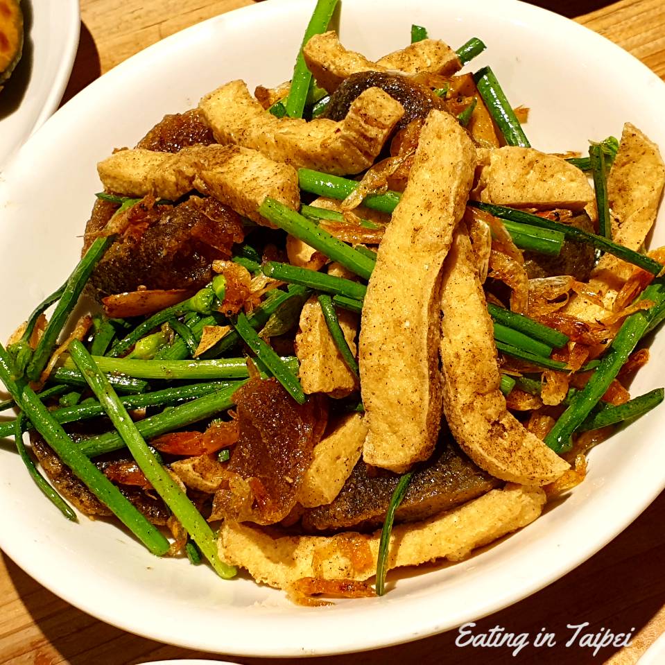 Stinky tofu strips, century egg, leek flowers, and tiny little dried shrimp